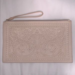 Cream colored BCBG clutch with stitching pattern